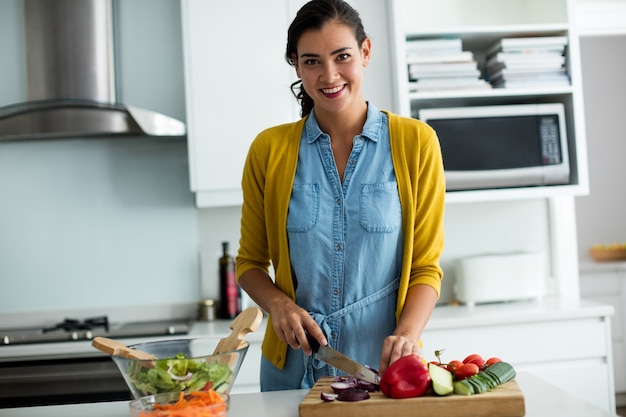 Portrait of woman preparing food in the kitchen at home