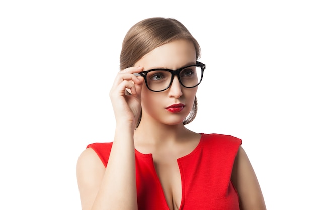 Portrait of woman in red dress and glasses looking up and thinking with open mouth