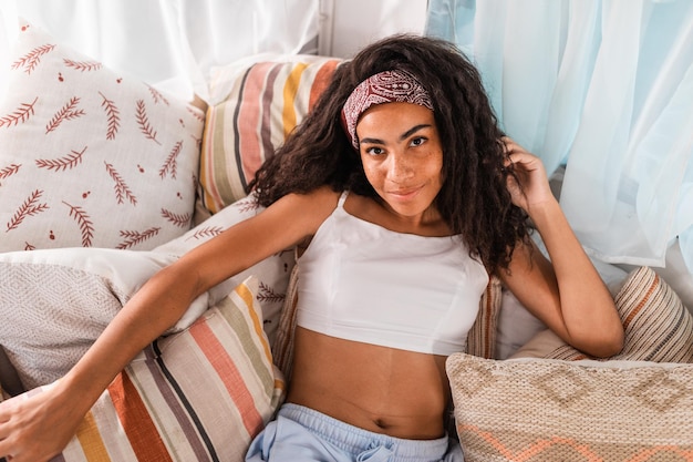 Portrait of woman relaxing on bed at home