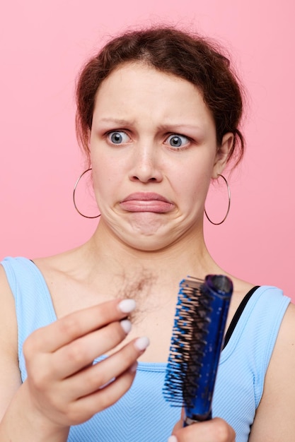 Photo portrait of a woman removes hair on a comb dissatisfaction lifestyle unaltered