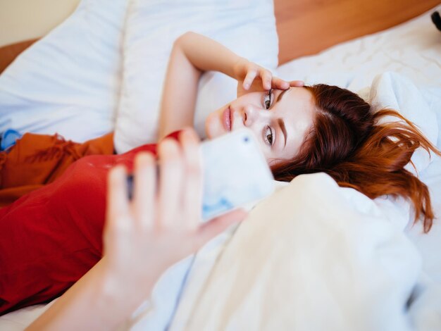 Portrait of woman resting on bed at home