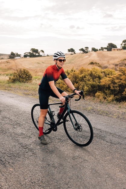 Portrait of woman riding bicycle on road