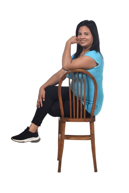 Portrait of a woman sitting on a chair isolated