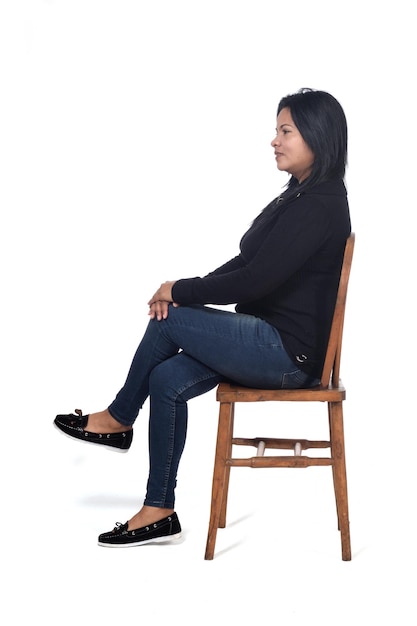 portrait of a woman sitting on a chair in white background, legs crossed