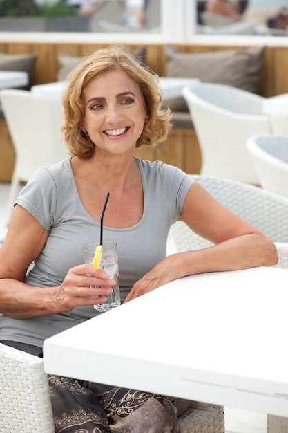 Portrait of a woman sitting at restaurant with drink