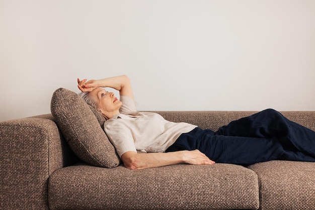 portrait of woman sitting on sofa at home