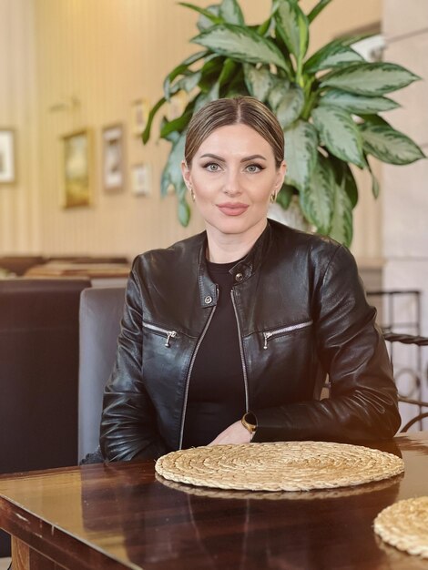 Portrait of a woman sitting at a table in a cafe