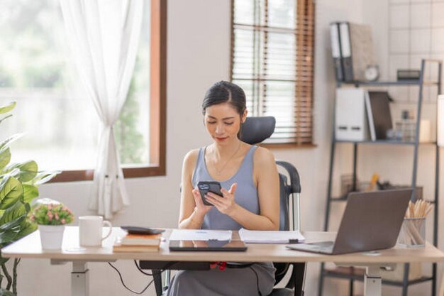 Portrait woman of smiling Happy Young Asian female freelancer working at home Asian finance accounting office concept