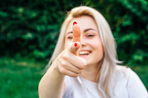 Portrait woman smiling making shot of fingers in camera with happy face