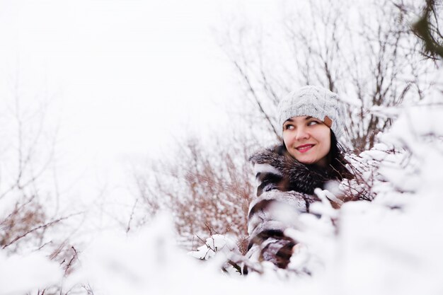 Portrait of woman in a snow bushes