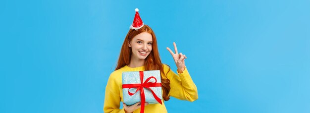 Portrait of woman standing against blue background