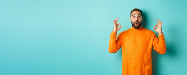 Portrait of woman standing against blue background