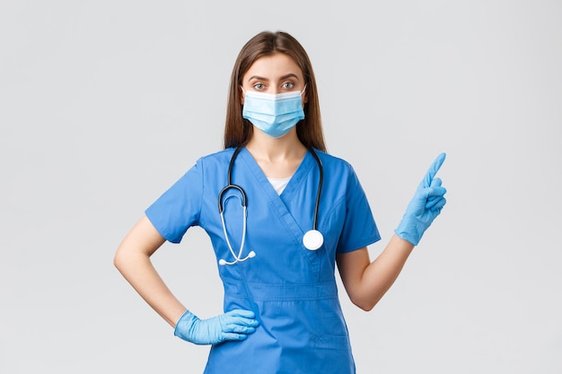 portrait of woman standing against blue background