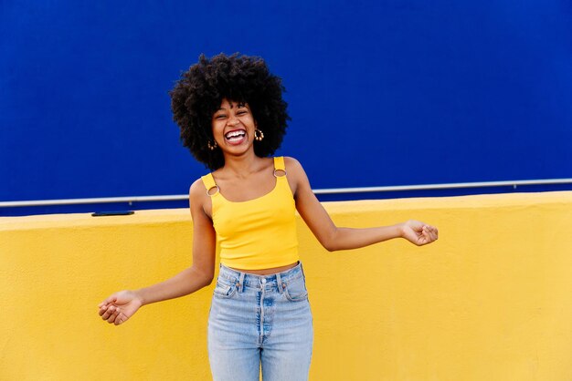 Portrait of woman standing against blue sky