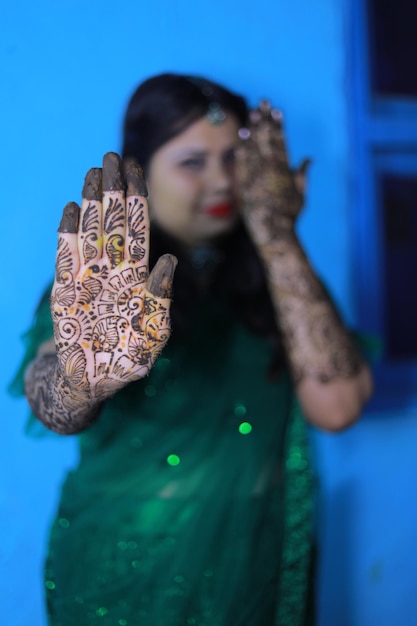 Portrait of woman standing against blue wall