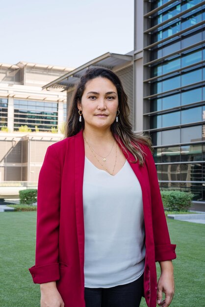 Portrait of woman standing against building