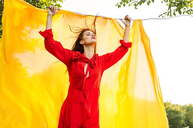 Portrait of woman standing against curtain