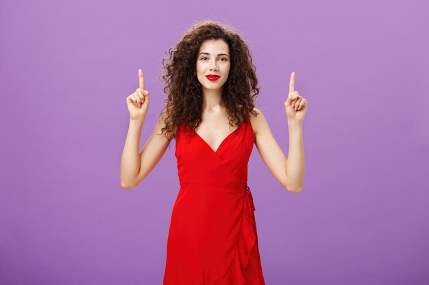 Portrait of a woman standing against gray background