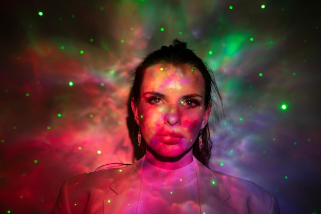 Portrait of woman standing against multi colored background