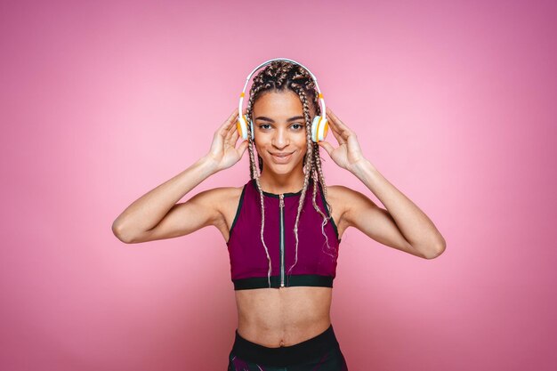 Portrait of woman standing against pink background