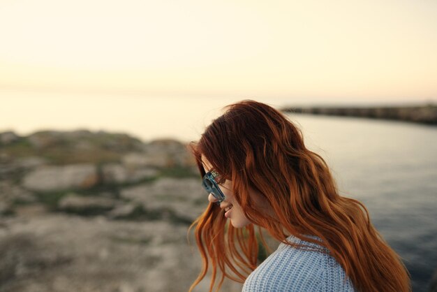 Portrait of woman standing against sky during sunset