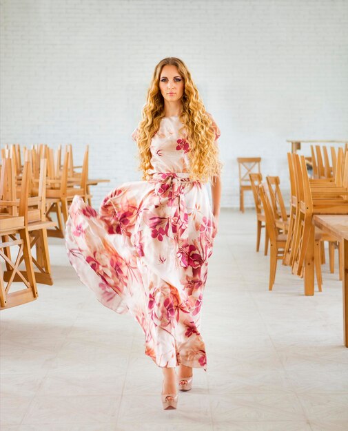 Portrait of woman standing against tiled floor