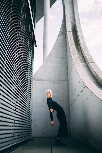 Portrait of woman standing against wall