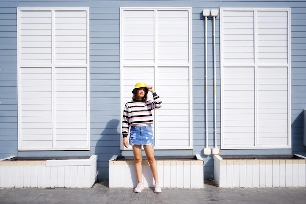 Portrait of woman standing against wall