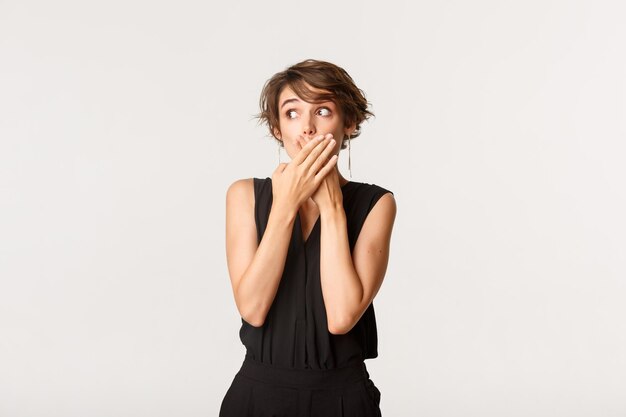 Portrait of woman standing against white background