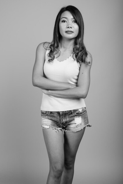 Portrait of woman standing against white background