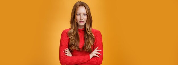 Portrait of woman standing against yellow background