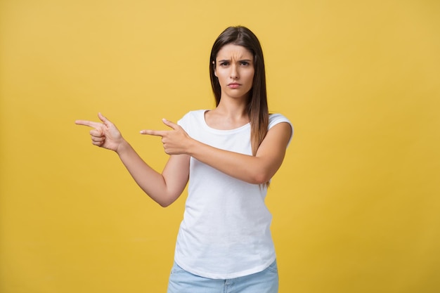 Portrait of woman standing against yellow background