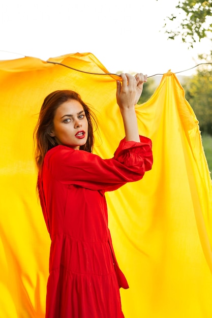 Portrait of woman standing against yellow wall