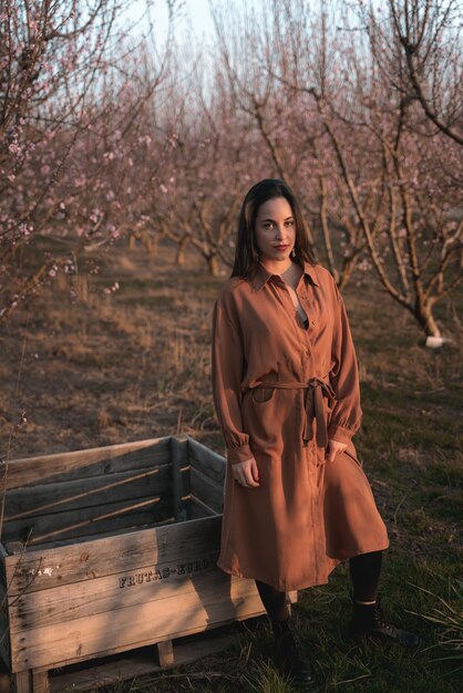 Portrait of woman standing by bare tree