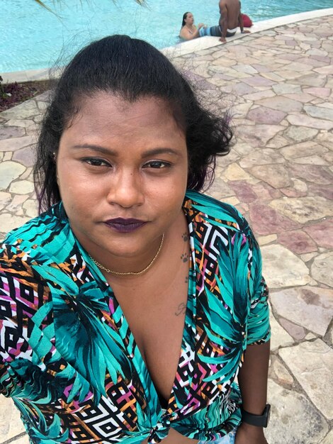 Portrait of woman standing by swimming pool