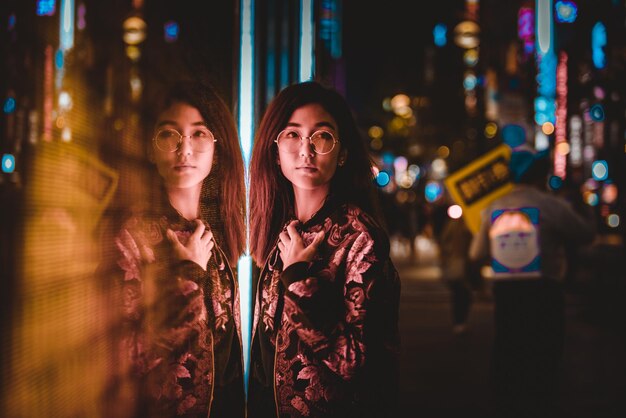 portrait of woman standing in city at night