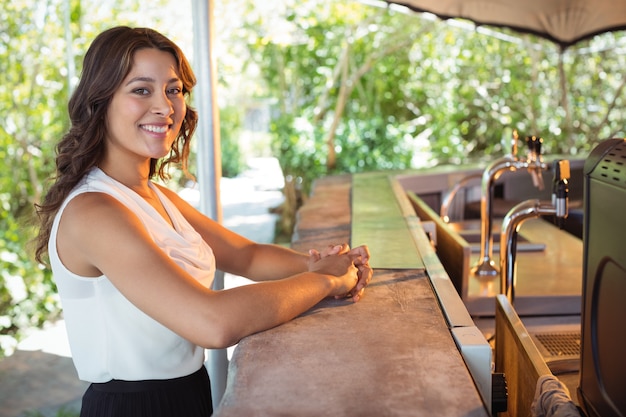 Portrait of woman standing at counter