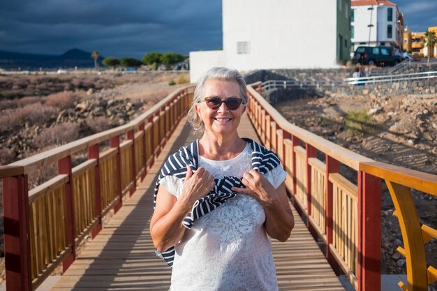 Portrait of woman standing on footbridge