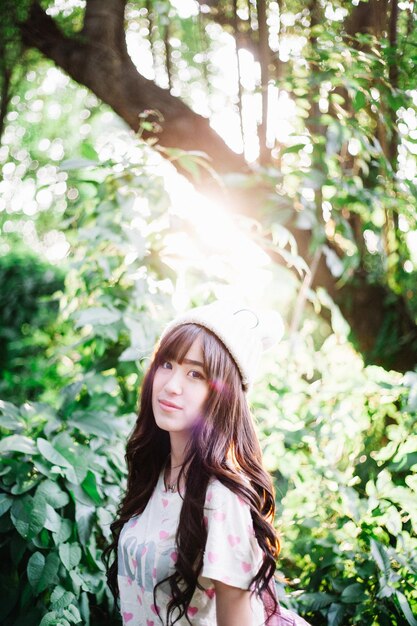 Portrait of woman standing in forest