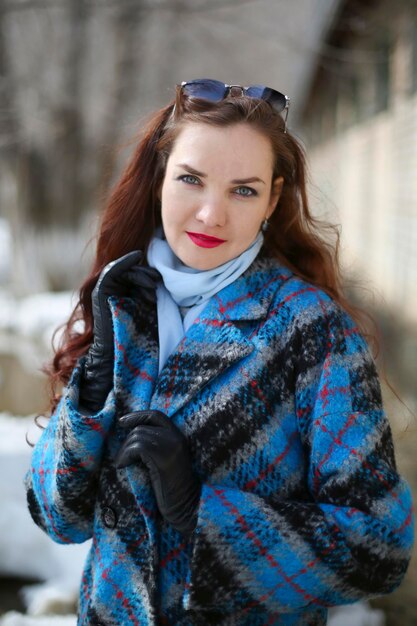 Portrait of woman standing outdoors during winter