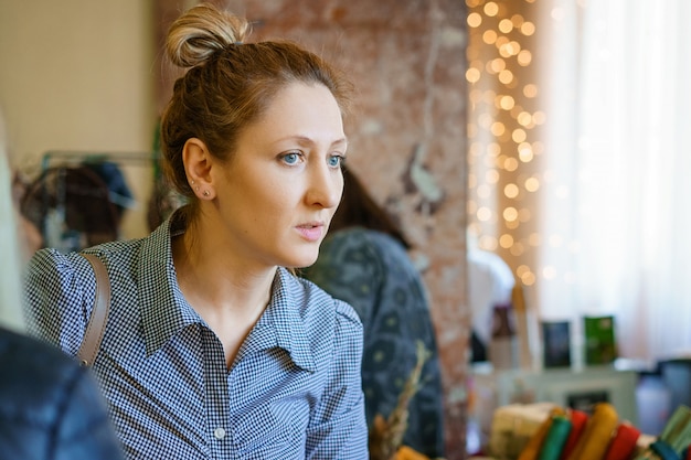 Photo portrait of a woman in the store, which chooses jewelry.