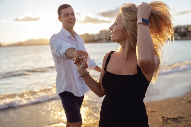 Portrait of woman straightening her hair looking to side at sunset