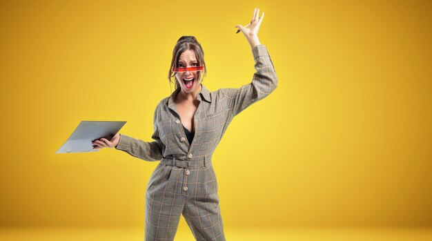 Portrait of a woman in a suit with a tablet