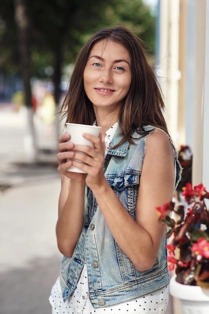 Portrait of a woman on sunny day with a cup of coffee