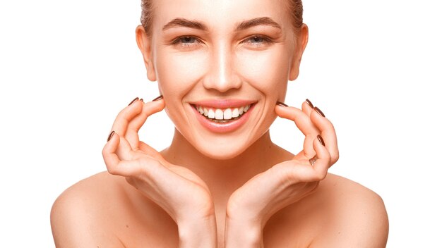 Portrait of a woman touching face over white background