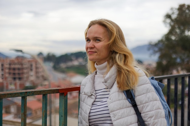 Portrait of a woman in a tourist on the background of the city