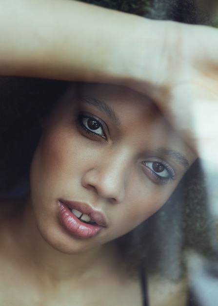 Portrait of a woman trough a window glass