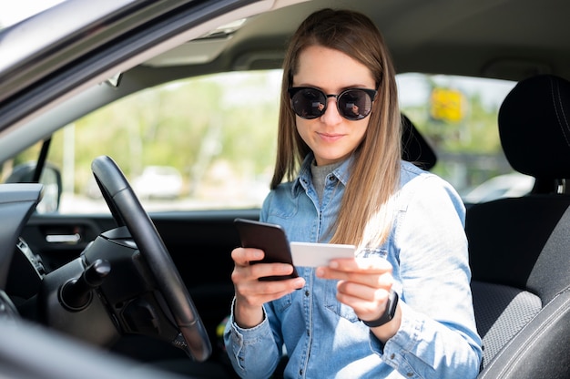 Portrait of woman typing card details to shop online