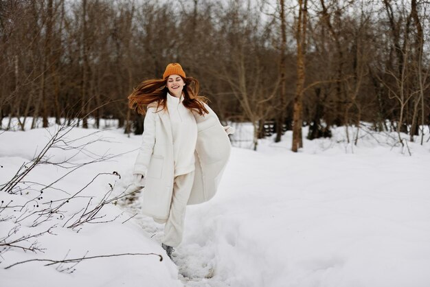 Portrait of a woman walk in winter field landscape outdoor\
entertainment walk in the winter forest high quality photo