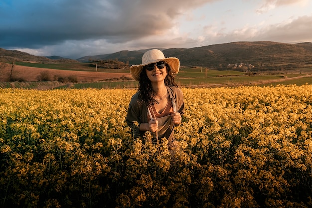 Portrait of woman walking among flowers in the countryside. Melancholy concept
